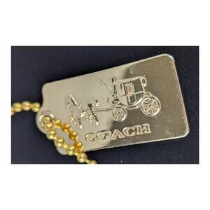 Coach metal bag tag 1.75"x7/8" stagecoach name on bottom.Ball chain included
EUC